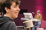 A close up of a smiling participant in a music workshop