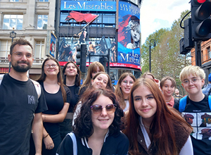 Group of Creative Influencers Teenagers in front of the Theatre in London which is showing Les Miserables