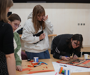 Four Creative Influencers working on making a handheld sign