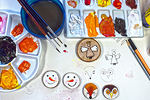 Handmade christmas stamps with paint supplies next to them