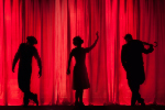 three silhouettes of people posing in front of a red theatre curtain
