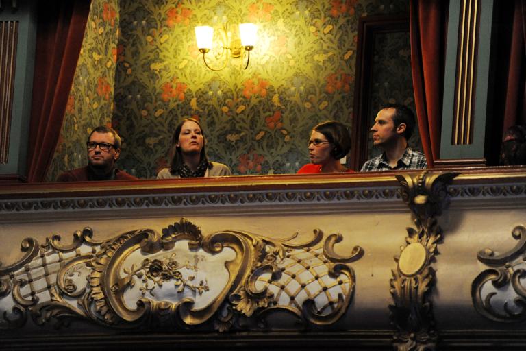 four people sat in the box at the theatre