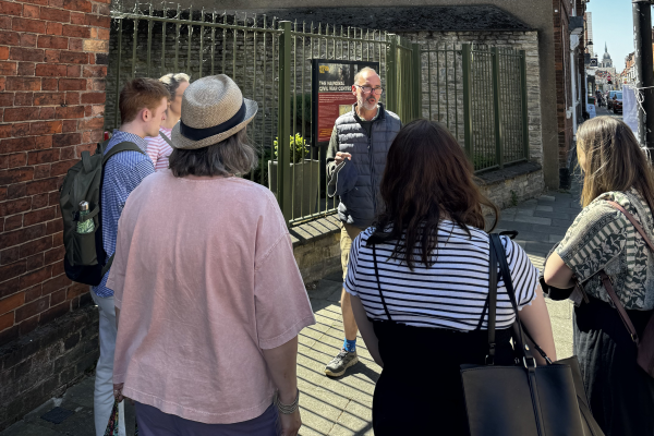 Guide leading a walking tour group outside the National Civil War Centre in Newark’s historic town centre.